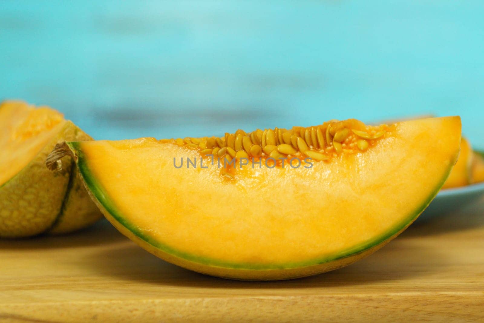 Piece of melon, close up of a table. How to peel and seed melon, close up process by darksoul72