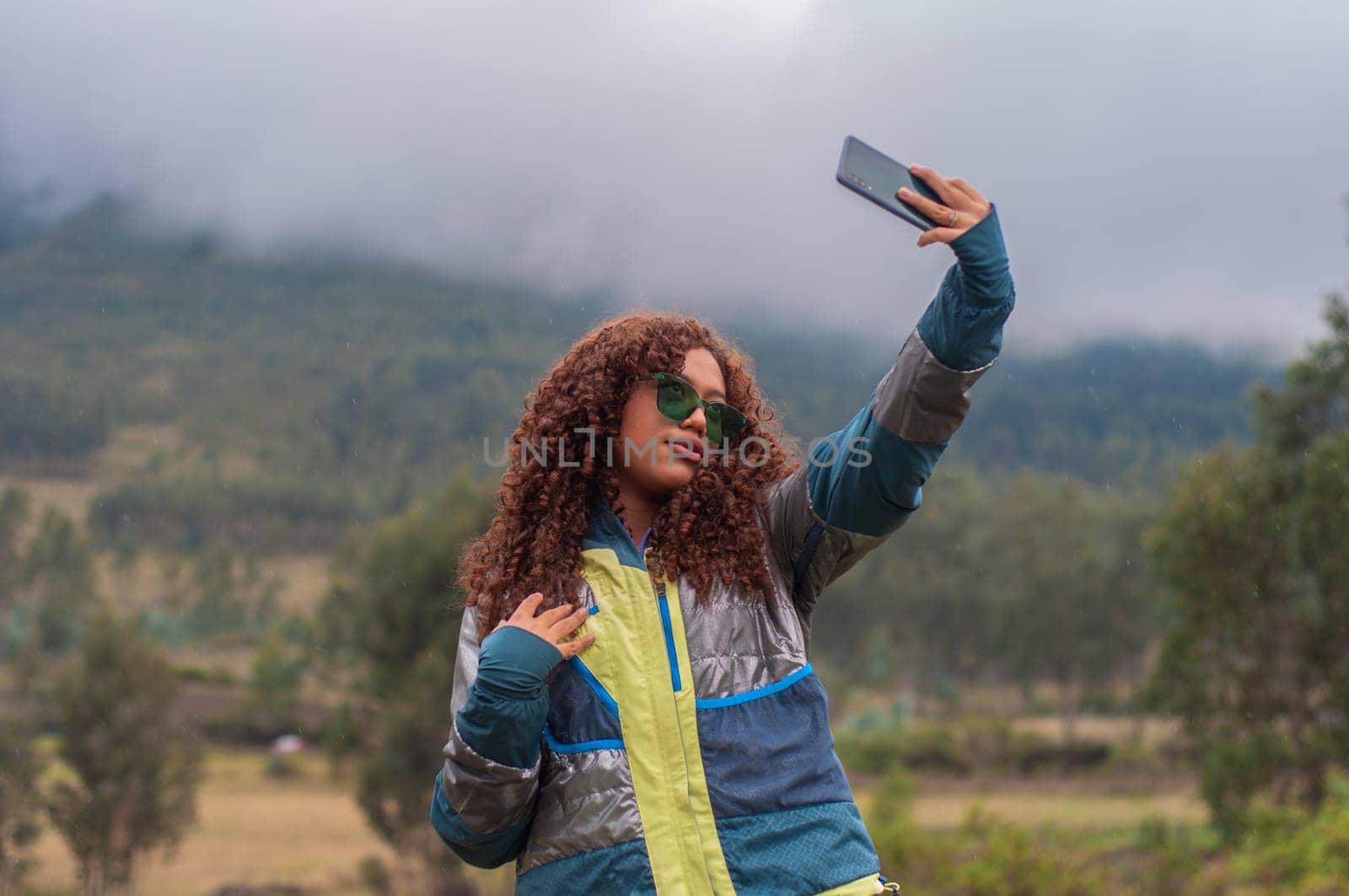 generation z latina influencer creating social media content for her followers from a mountain in ecuador. High quality photo