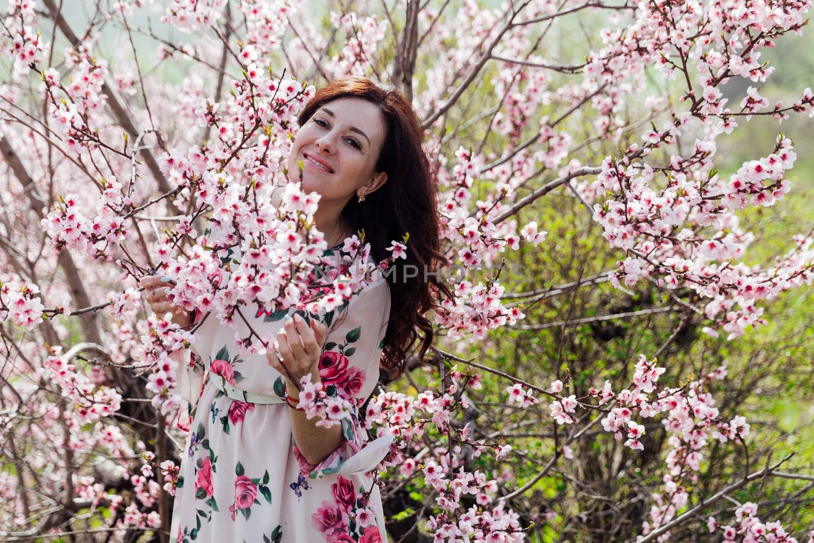 beautiful woman brunette in flowering trees spring nature travel walk by Simakov