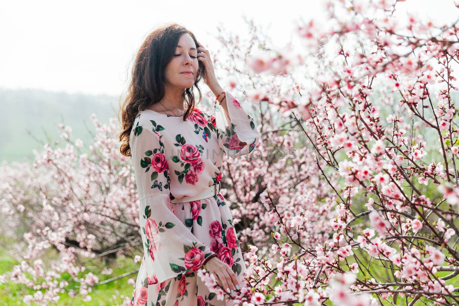 beautiful woman brunette in flowering trees spring nature travel walk by Simakov