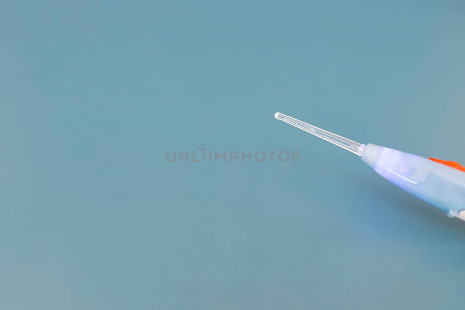 Mockup Top View Ear Wax Removal Glass Stick Or Curette on Blue Background, Copy Space For text. Closeup Auricle and Inner Ear Tool Cleaner. Personal Care Hygiene Essentials. Horizontal Plane