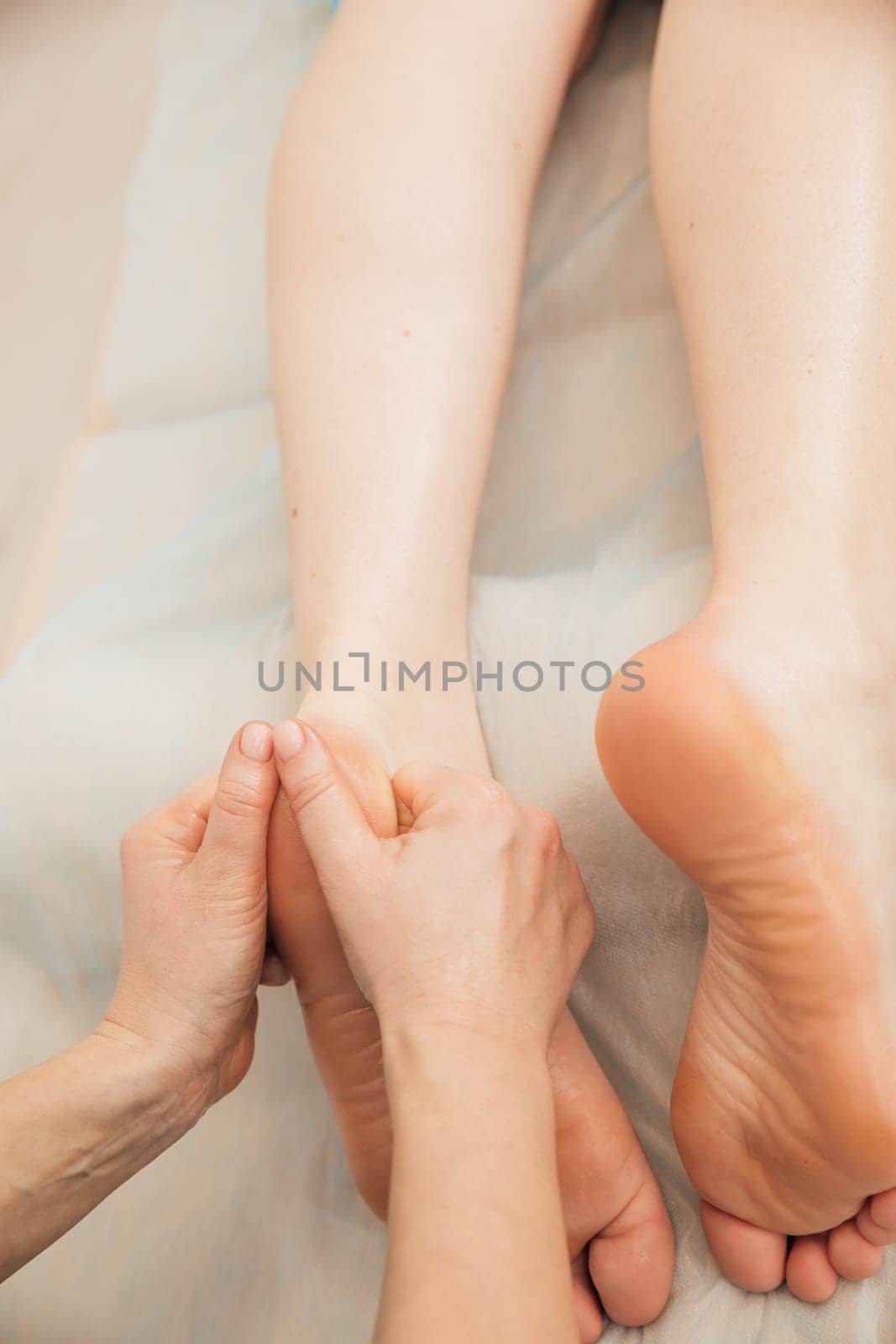 A health massage therapist does a foot massage for a client in the office