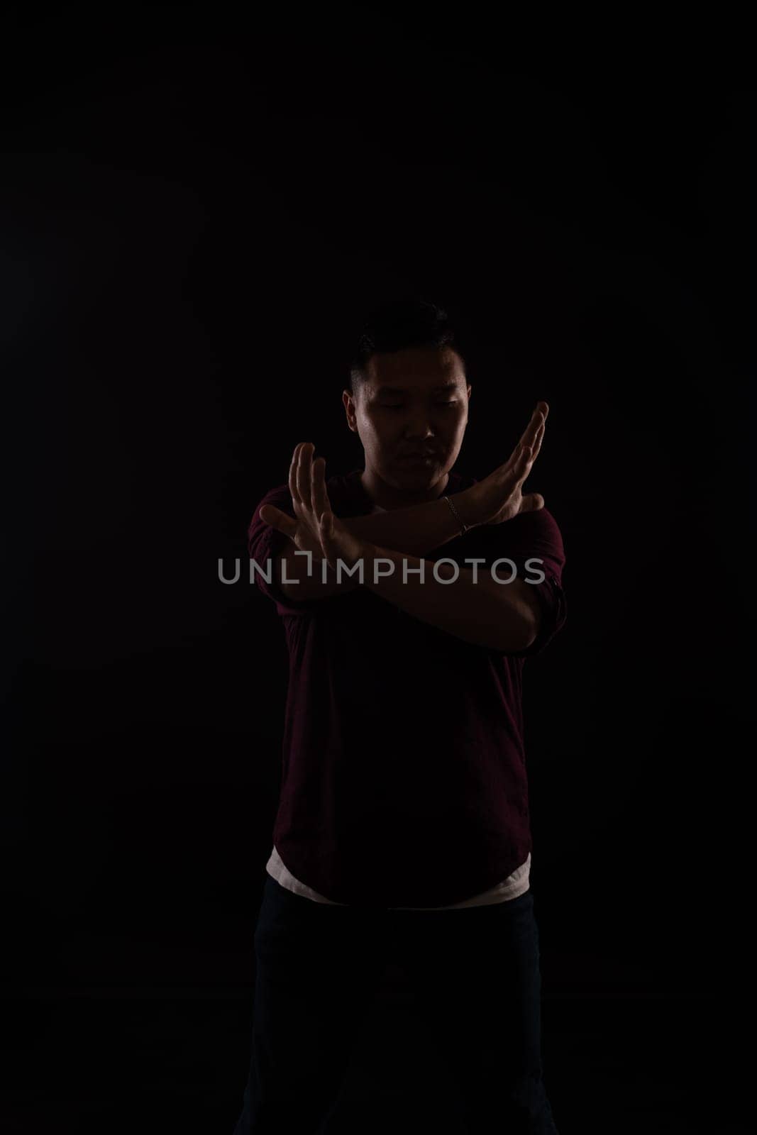 A man dancing in the dark in a studio music