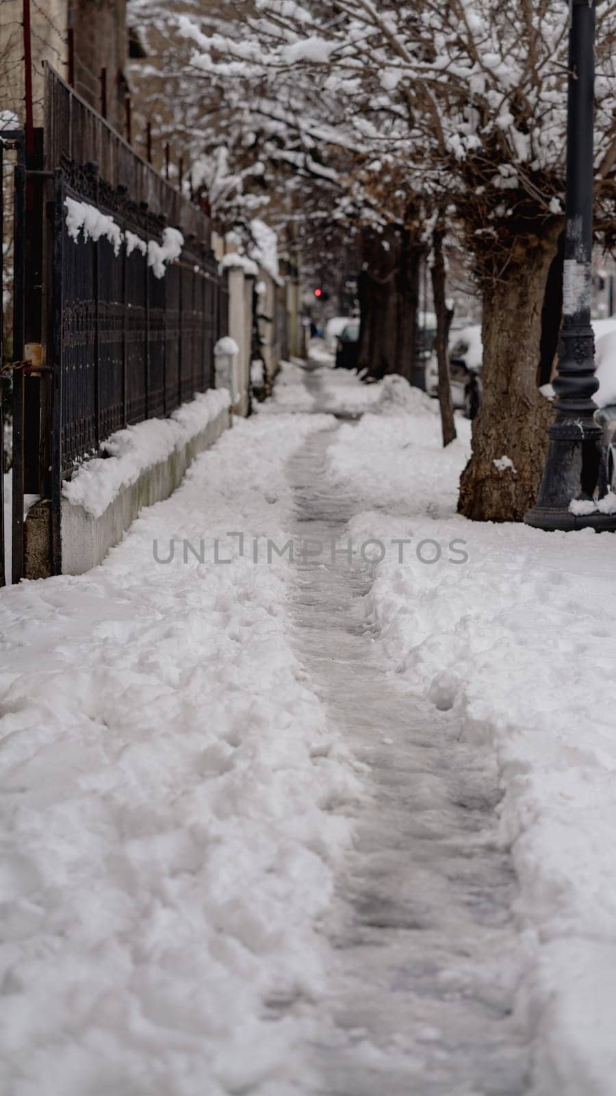 Path way made by people walking thru the snow in the morning. Path in heavy snow. Winter concept snow-path in the morning light by vladispas