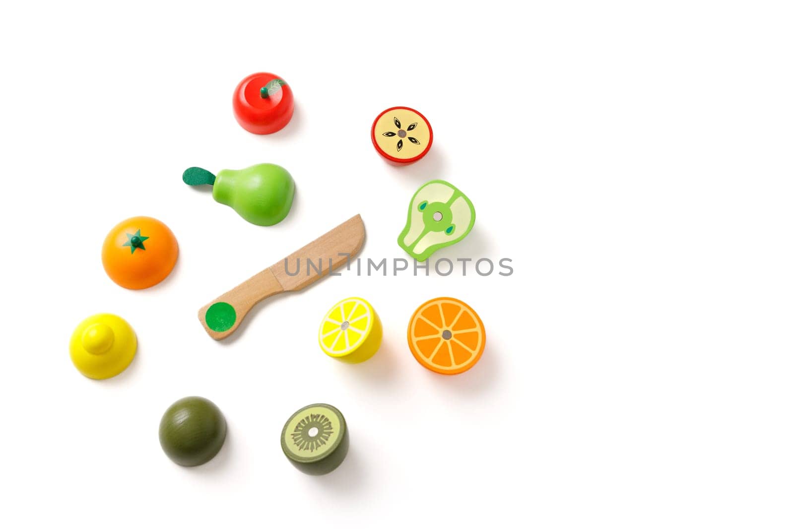 Top view on educational kid's set of toys in the form of cut fruits and a wooden knife, isolated on white background, copy space by Rom4ek