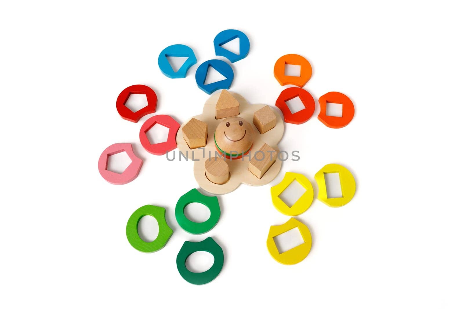 Wooden puzzle toy that develops logic and fine motor skills with colorful blocks of different shapes isolated on white background.