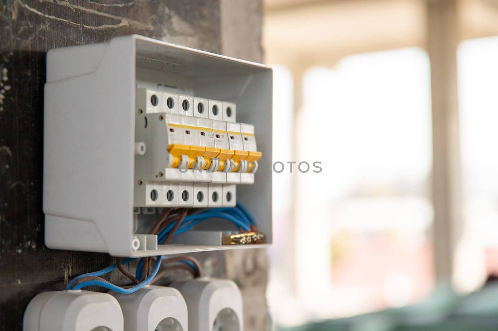 Temporary electrical panel with circuit breakers on a construction site.