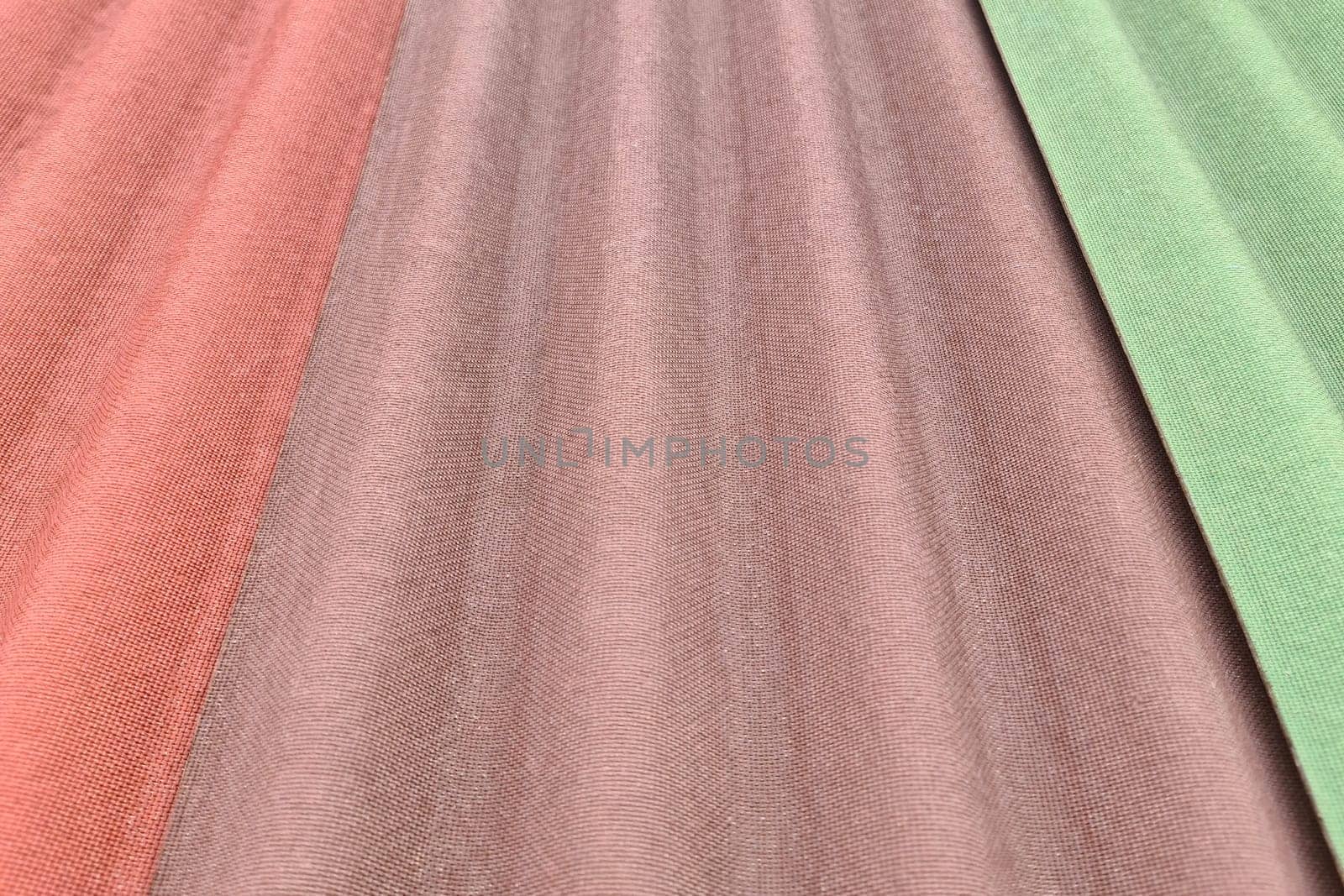 Close up on three sheets of ondulin of different colors. Modern cheap roofing material.