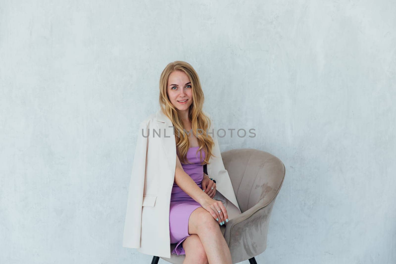 Portrait of beautiful fashionable blonde woman in dress and jacket by Simakov