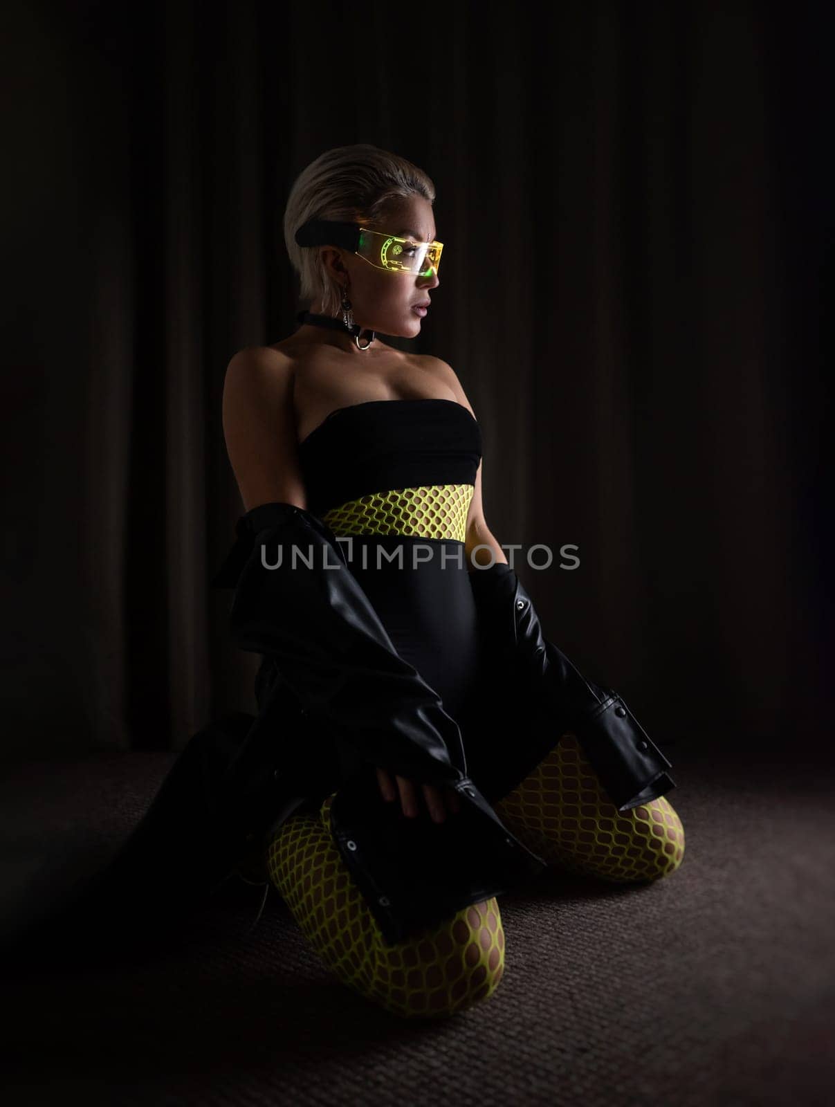 sexy girl in futuristic neon glasses and tight clothes and bright fishnet tights on a dark background in the room by Rotozey