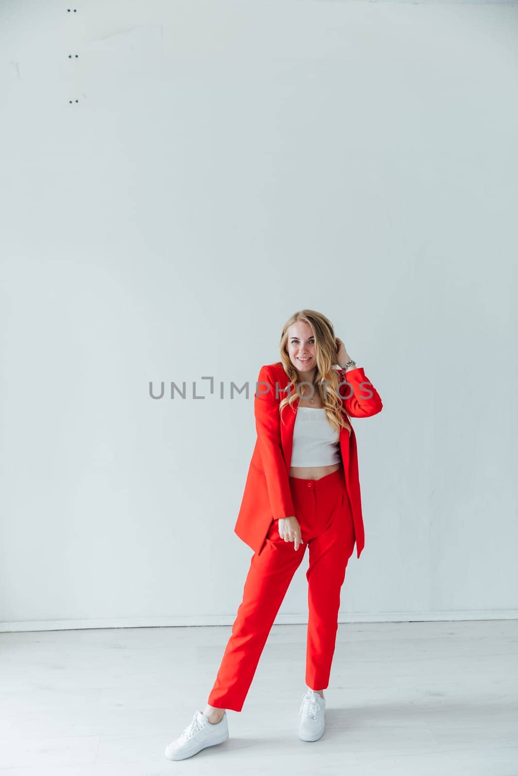 Beautiful blonde woman in red business suit