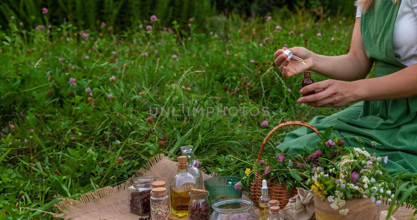 A woman makes herbal tincture. Selective focus. Nature.