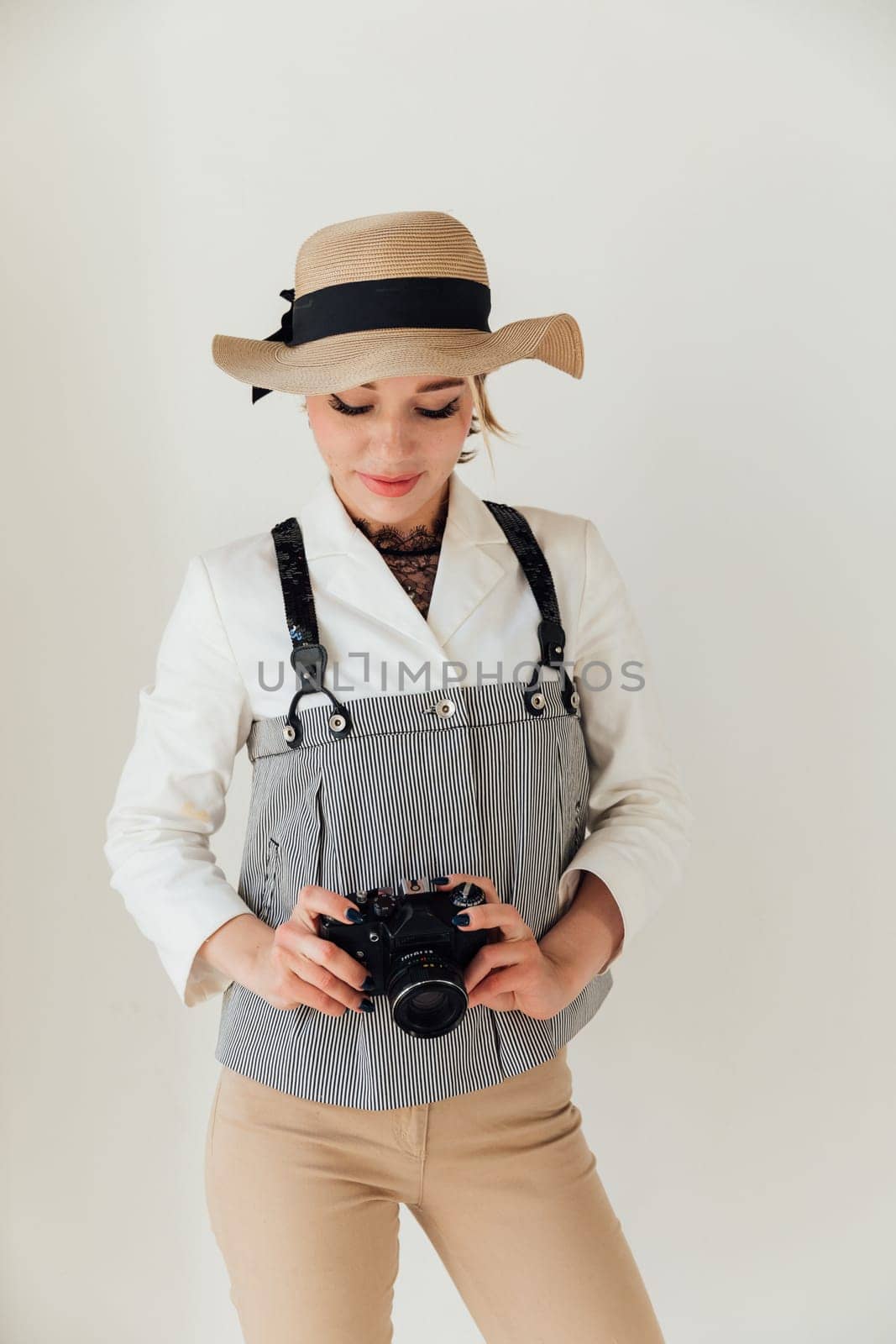 Female photographer taking pictures with vintage camera by Simakov