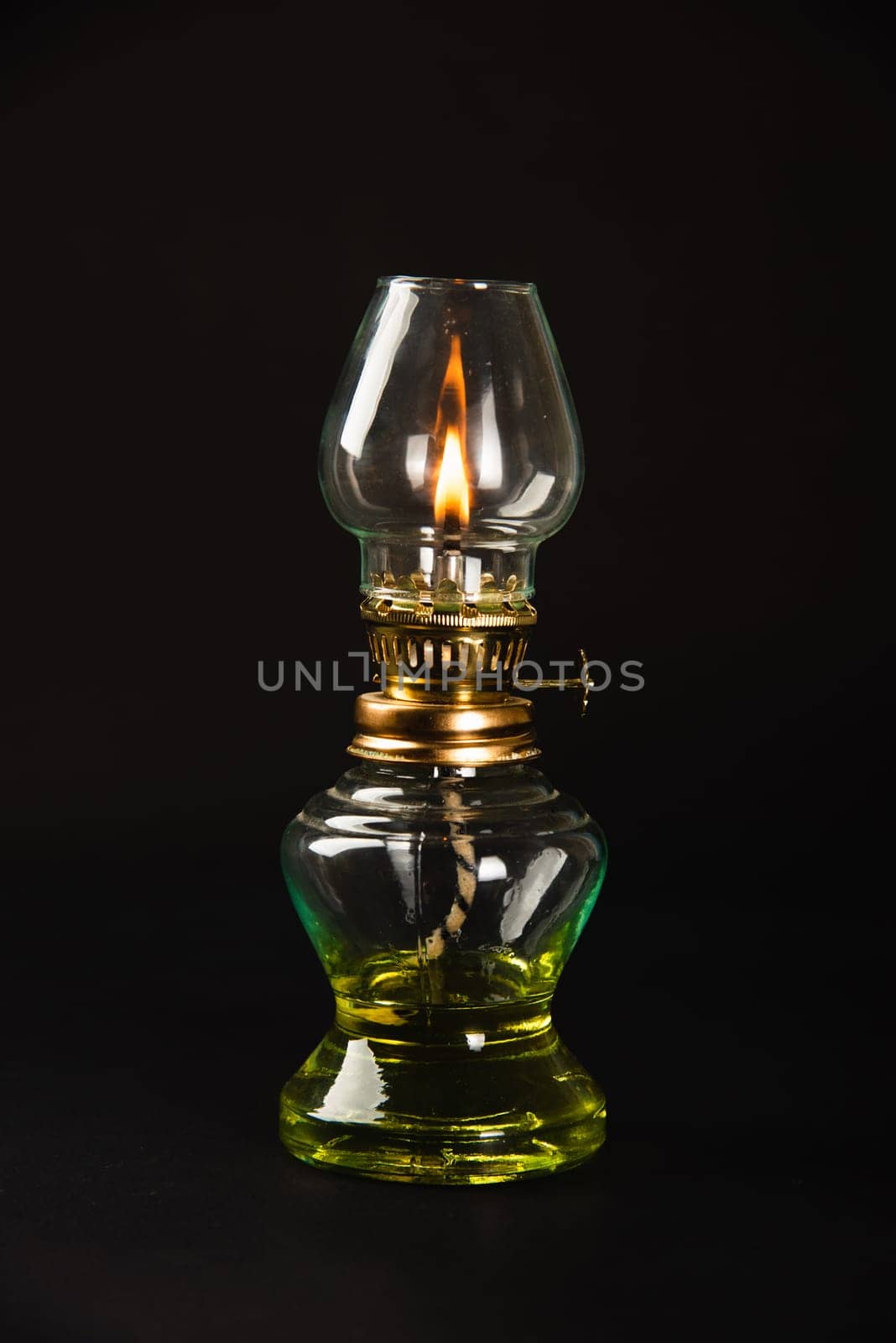 An antique oil lamp, symbolizing Diwali's essence, illuminated against a dark background. Perfect for conveying festive greetings and vintage aesthetics. by Sorapop