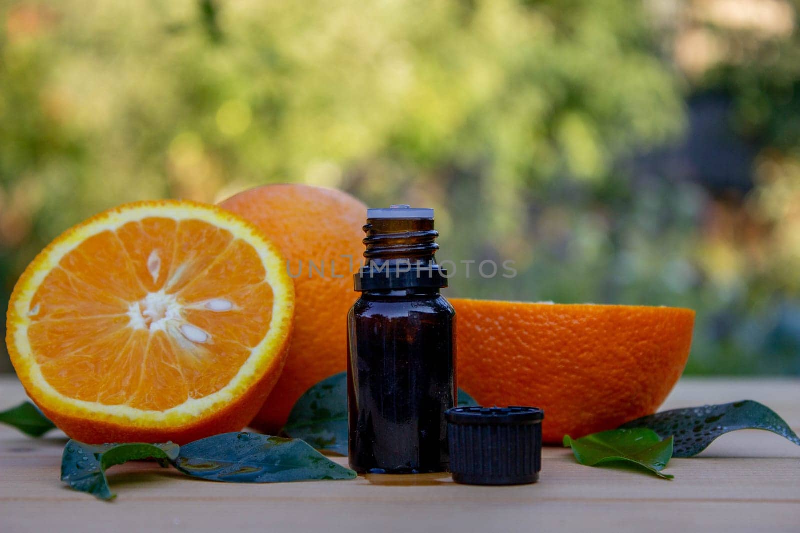 Essential extract of orange oil in a small bottle.