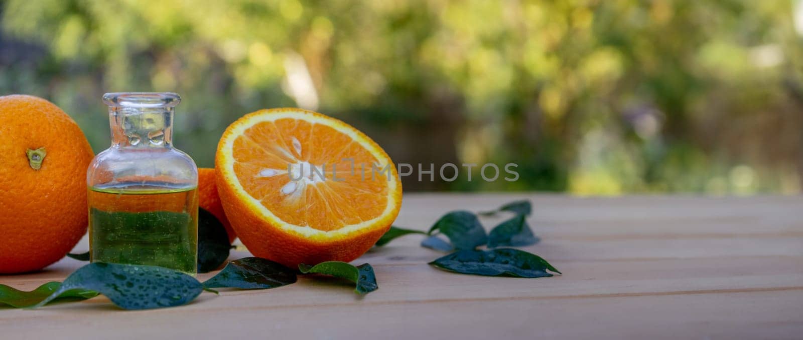 Essential extract of orange oil in a small bottle. Selective focus. by Anuta23