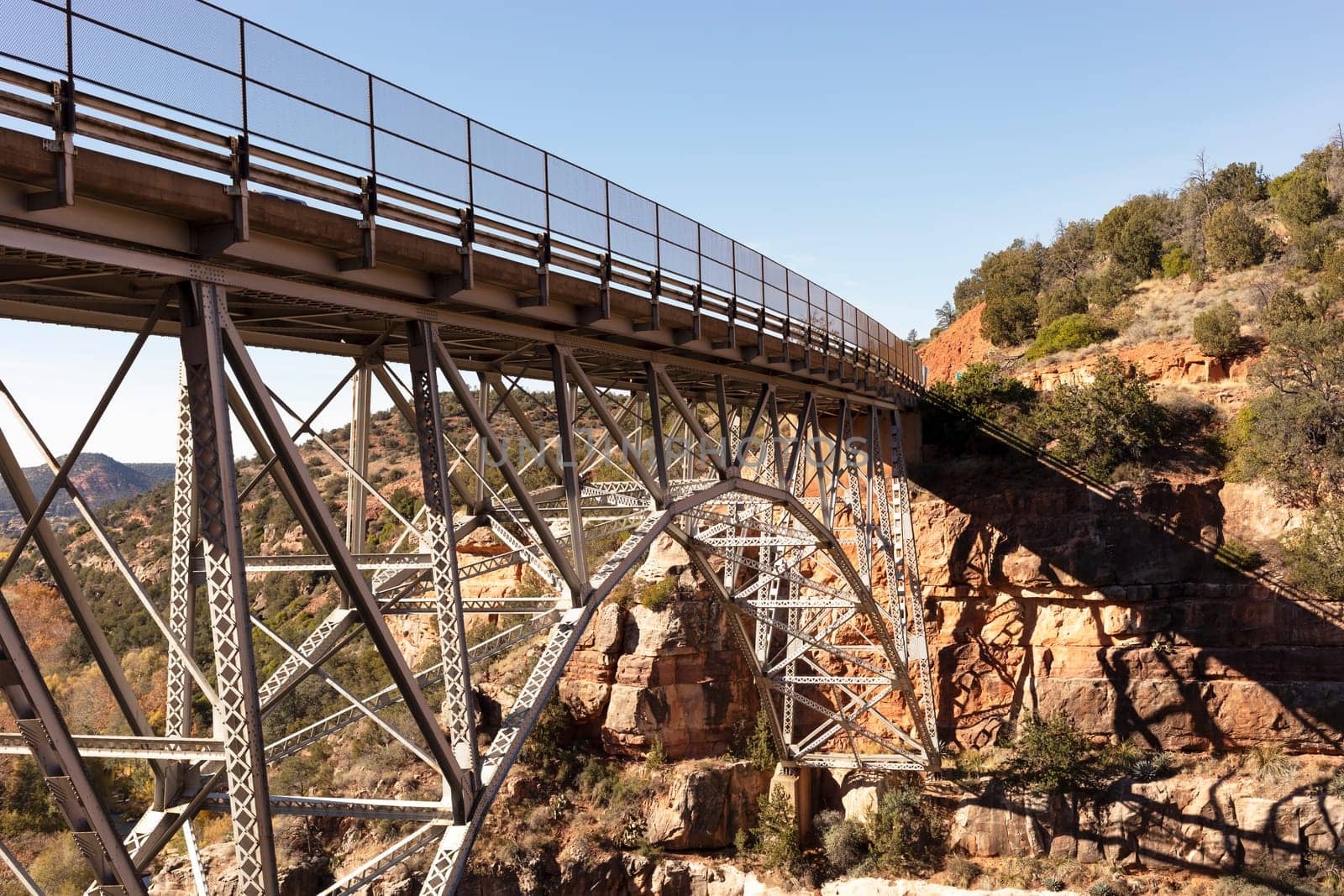 Metal Construction Of Bridge Supports Against Blue Sky And Rocks. Rivets And Braces On Metal Beams. Midgley Bridge, Sedona Arizona. Oak Creek Canyon, Coconino County by netatsi