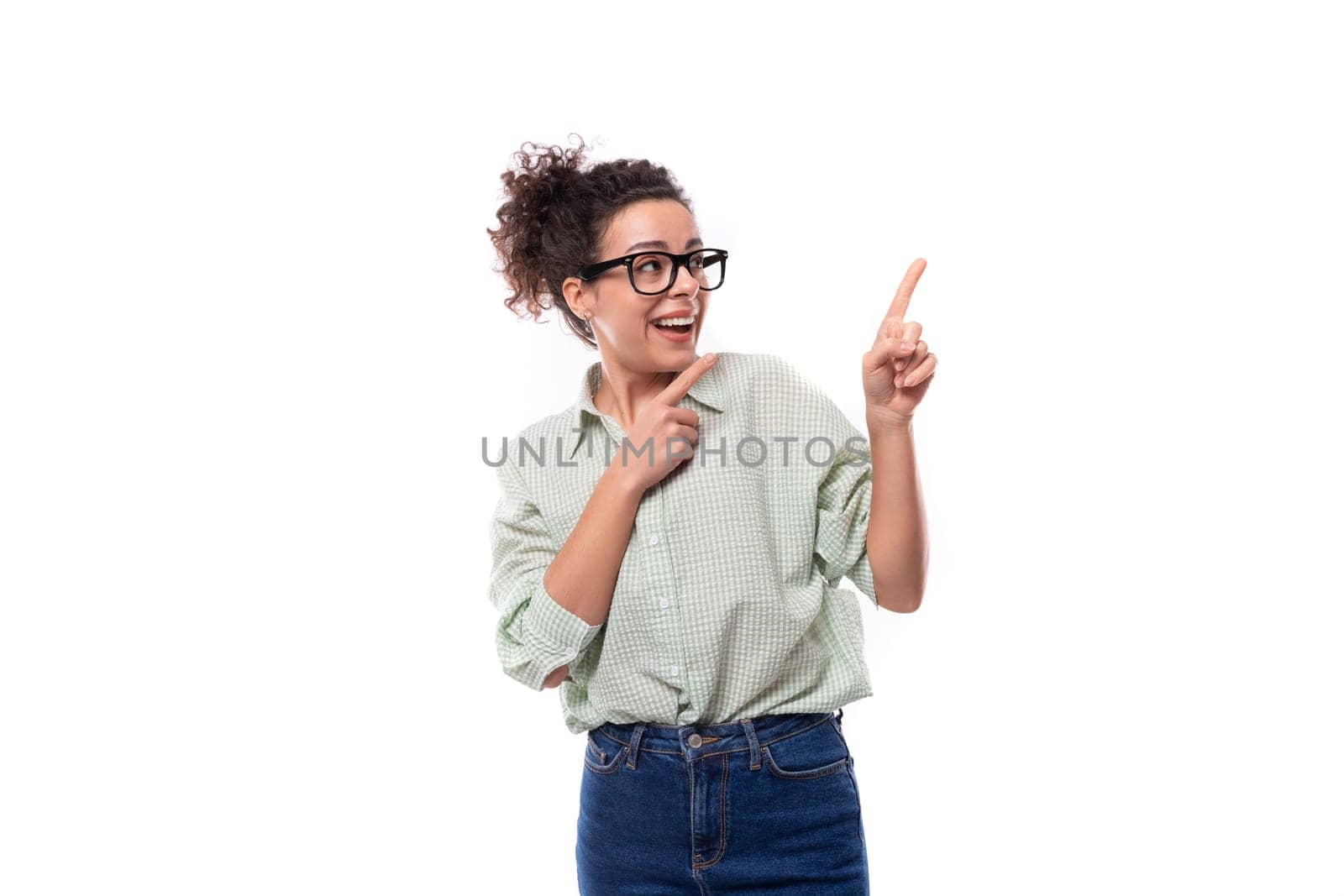 young energetic positive teacher woman with curly black hair dressed in a shirt and jeans.