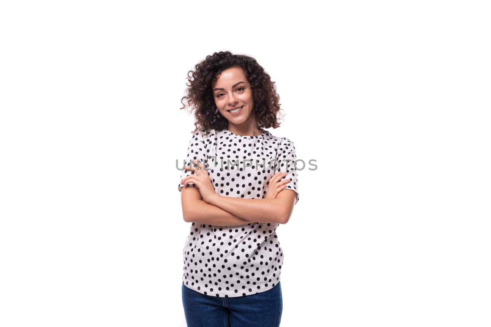 portrait of a slender curly young brunette dressed in a blouse on a white background with copy space.