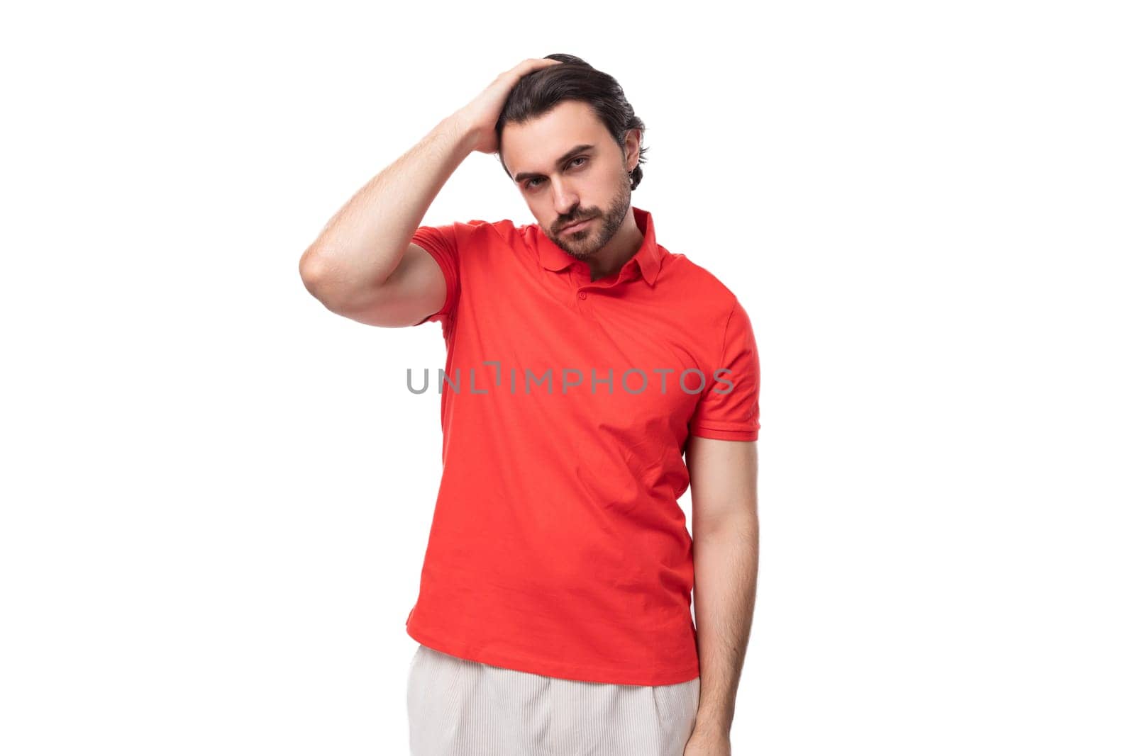 young brutal caucasian brunette man with beard wearing t-shirt is thinking about business strategy on studio background with copy space.