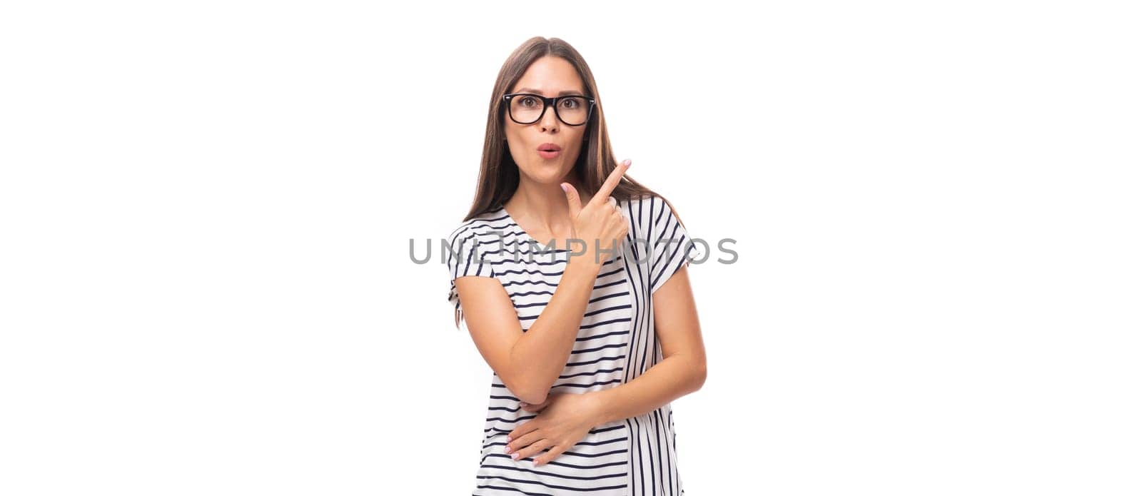 young pretty european brunette woman in a striped sweater gesturing actively on a white background with copy space by TRMK
