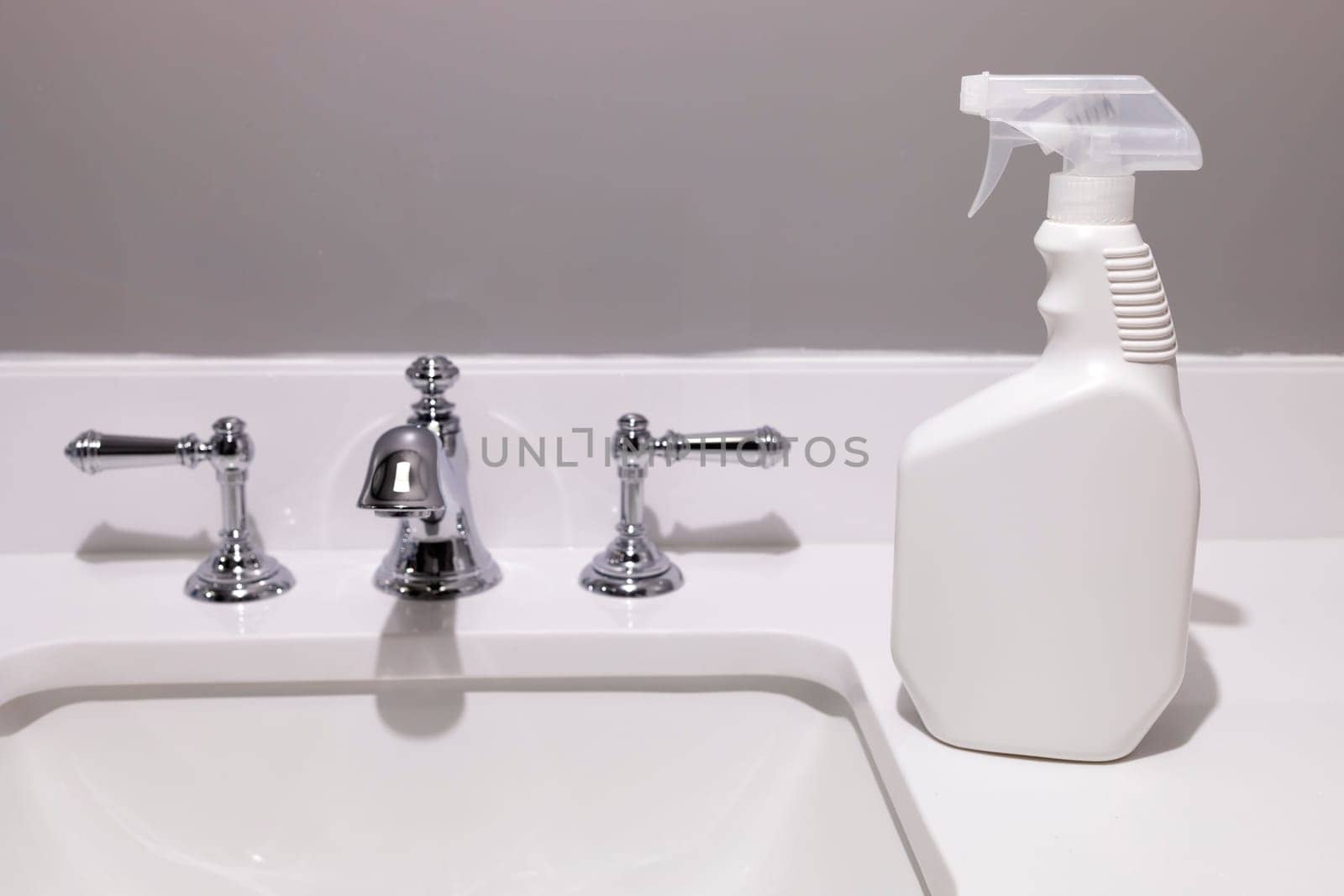 White Blank Plastic Spray Bottle On White Sink In Bathroom. Packaging Mockup. Unaltered, Spray Bottle, Hygiene. Lifestyle. Empty Place For Text Or Logo Horizontal Plane. Sanitary High quality photo