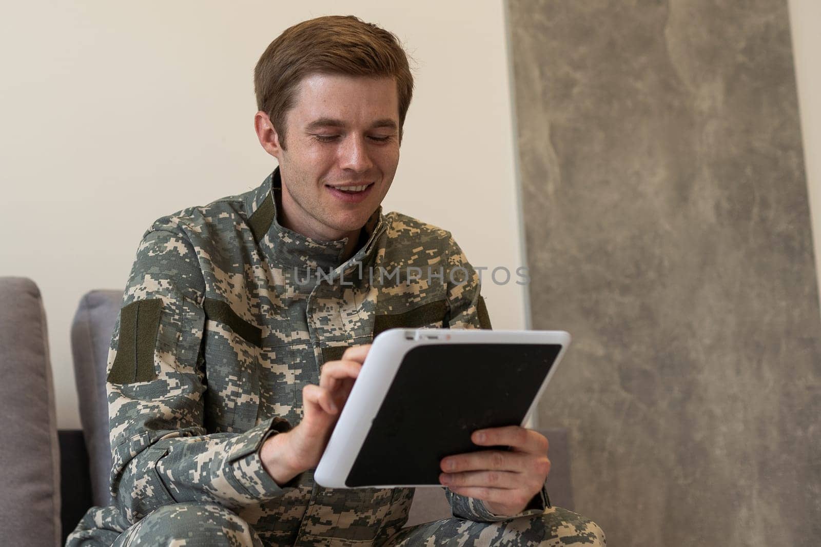 cheerful military man using digital tablet and having video call in office by Andelov13