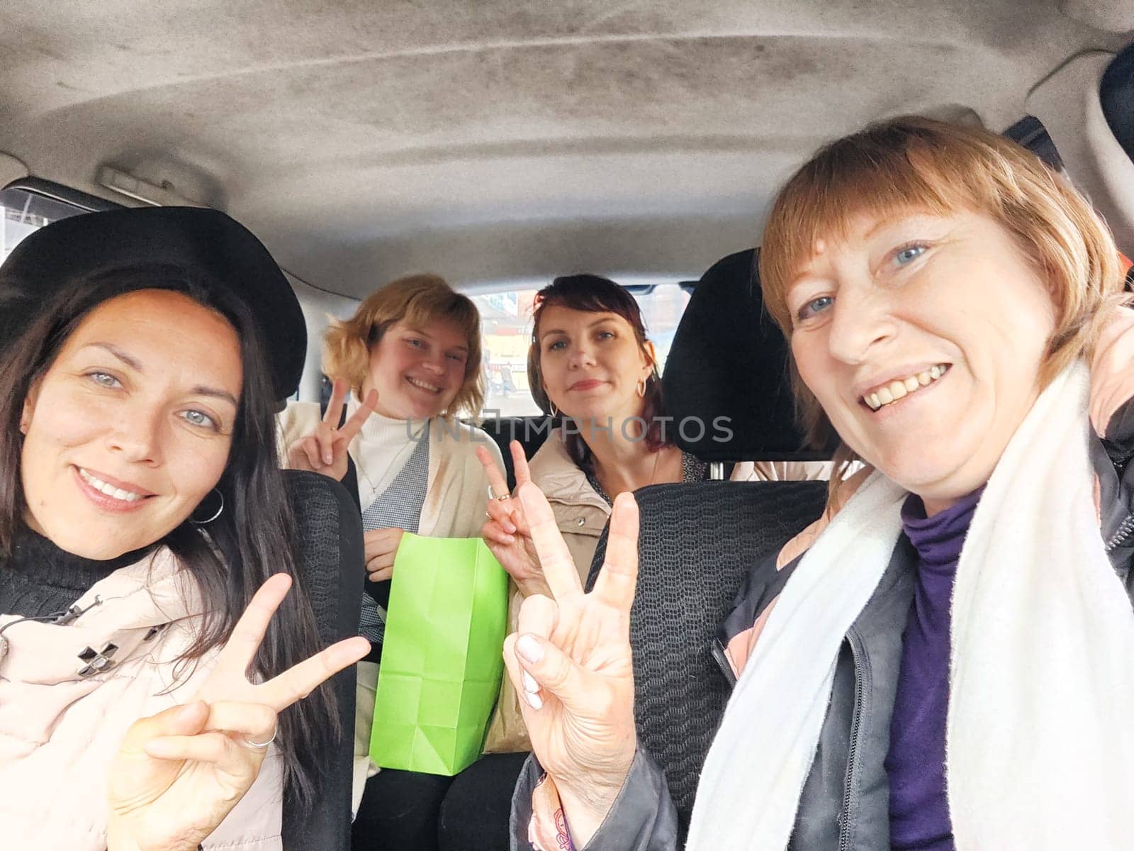 Funny girls in the car. Middle-aged women on journey. Tourists on a car tour