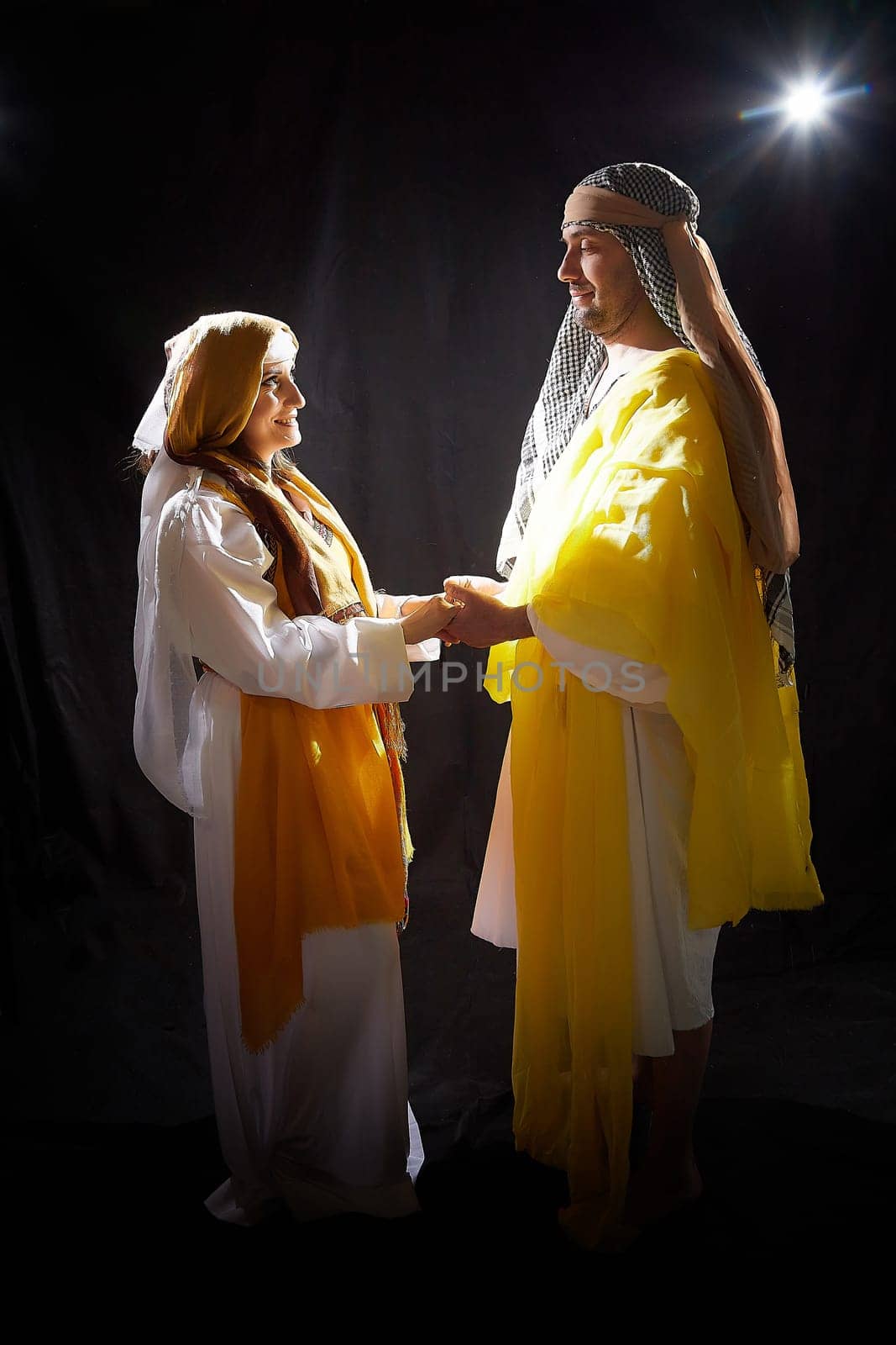 A couple in love or a married couple in stylized Eastern clothing from Israel, Palestine, Iran, Pakistan together. A tender photo session in the style of the Middle East and the Bible by keleny