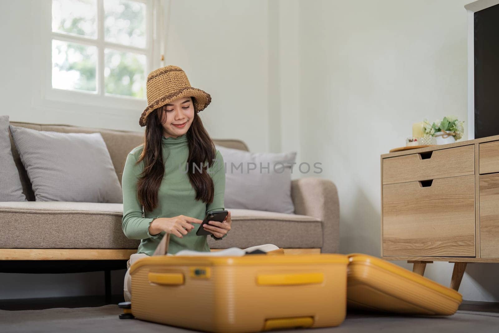 Beauty asian traveler woman packing prepare stuff and outfit clothes in suitcase travel bag luggage for holidays at home, weekend, tourist, journey.