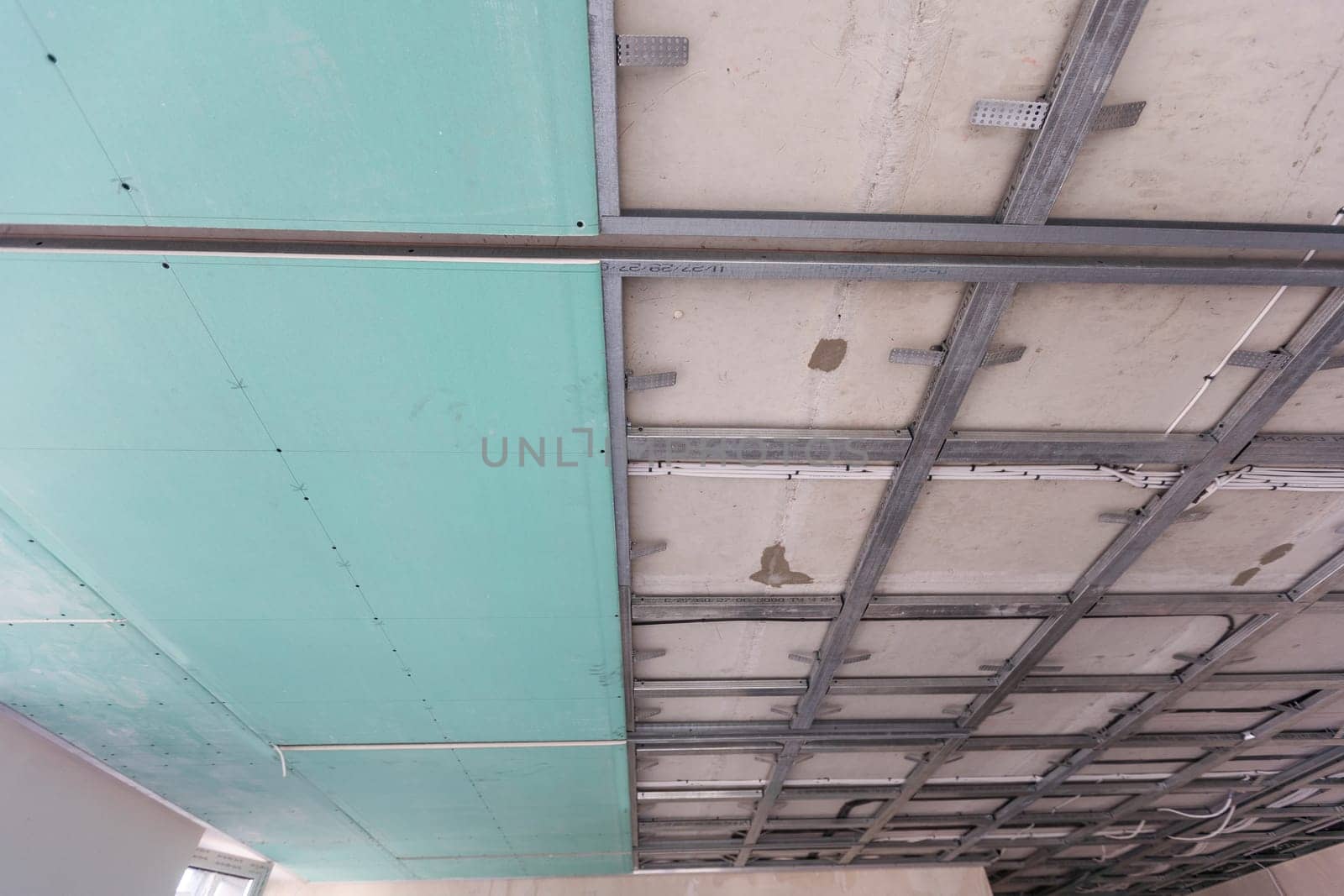 structure of ceiling suspension, installation of gypsum plasterboard and light. High quality photo