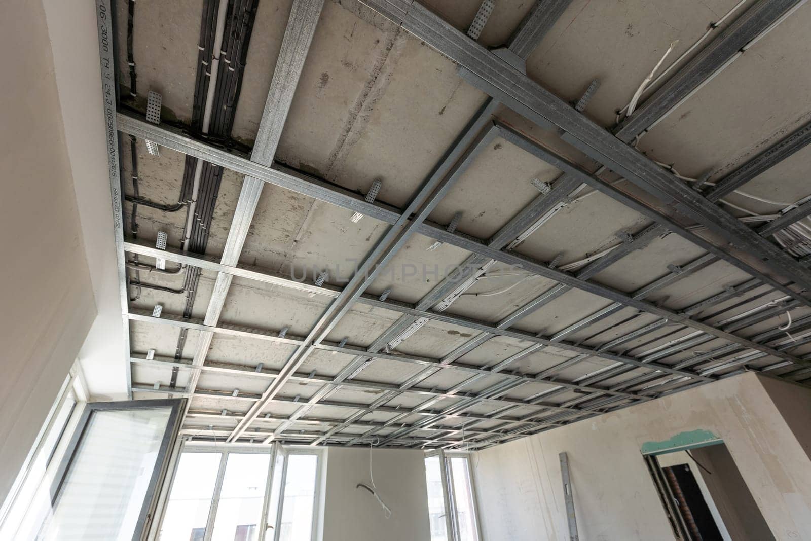 The metal frame of the ceiling, sound insulation, in the process of repairing an apartment. High quality photo