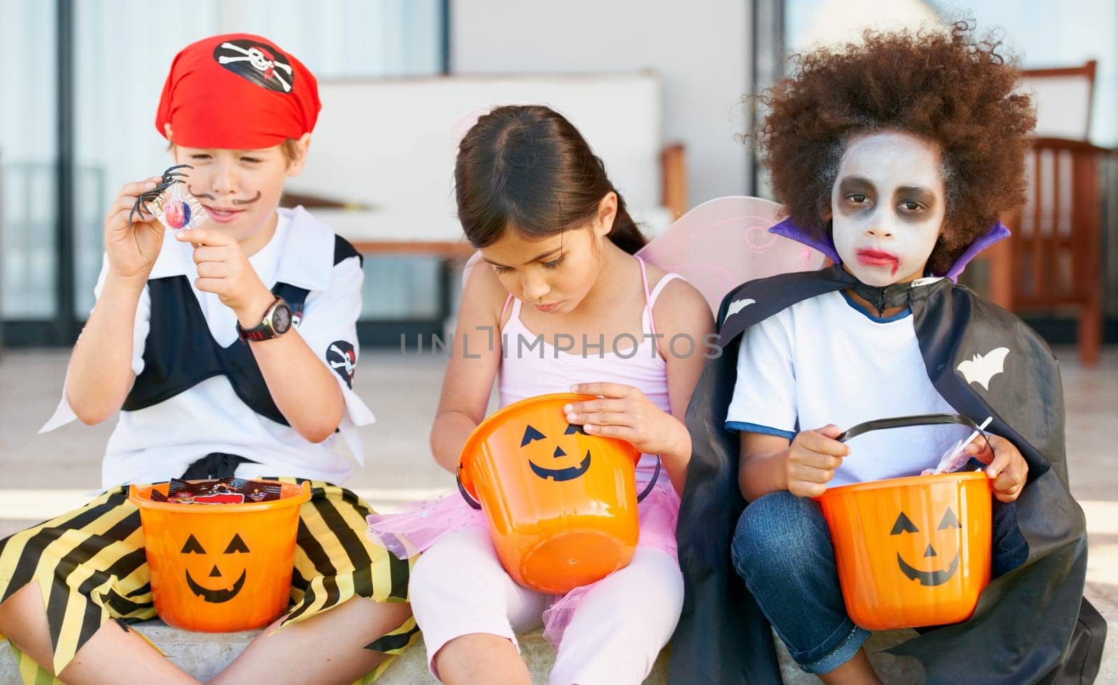 Children, halloween and candy bucket for holiday fun or vampire dress up, fairy or pirate role play. Friends, group and pumpkin basket as dessert or trick or treat celebration, fantasy or development.