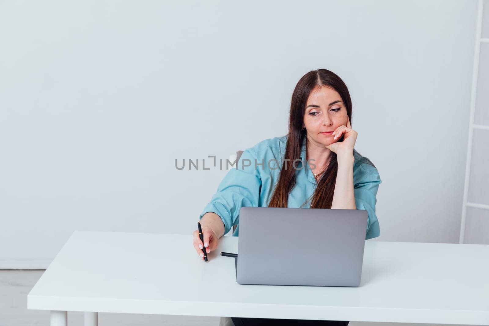 Business woman working online at computer in office by Simakov