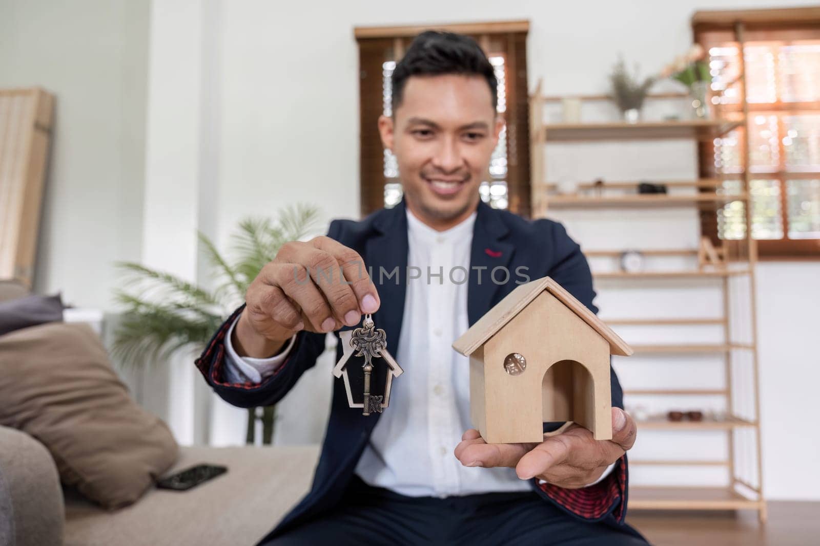 Real estate concept, businessman holds house icon. House in hand. Property insurance and security concept. and the symbol of the house.