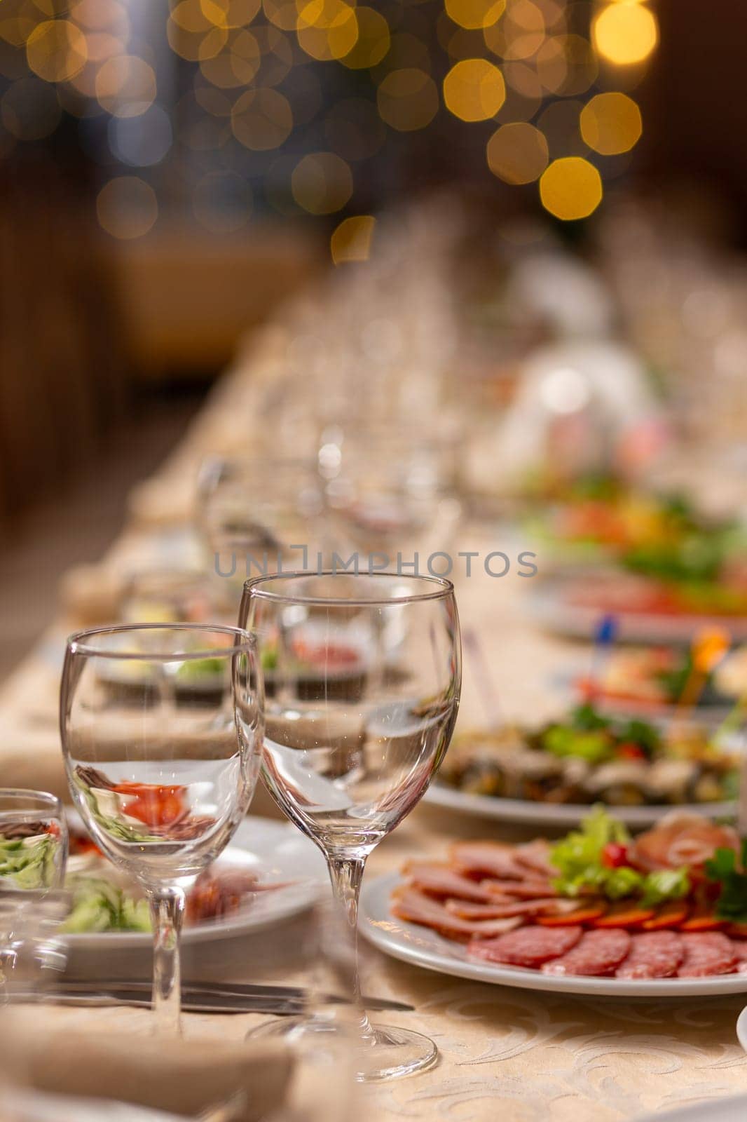 Served festive table with snacks, glasses, glasses, cutlery and napkins for a banquet on the occasion of a wedding or birthday or Christmas or other bright event in the restaurant