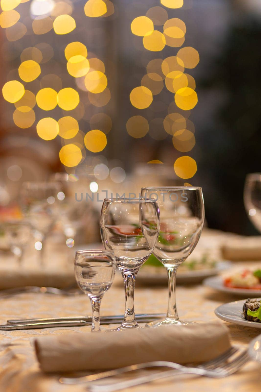 Served festive table with snacks, glasses, glasses, cutlery and napkins for a banquet on the occasion of a wedding or birthday or Christmas or other bright event in the restaurant