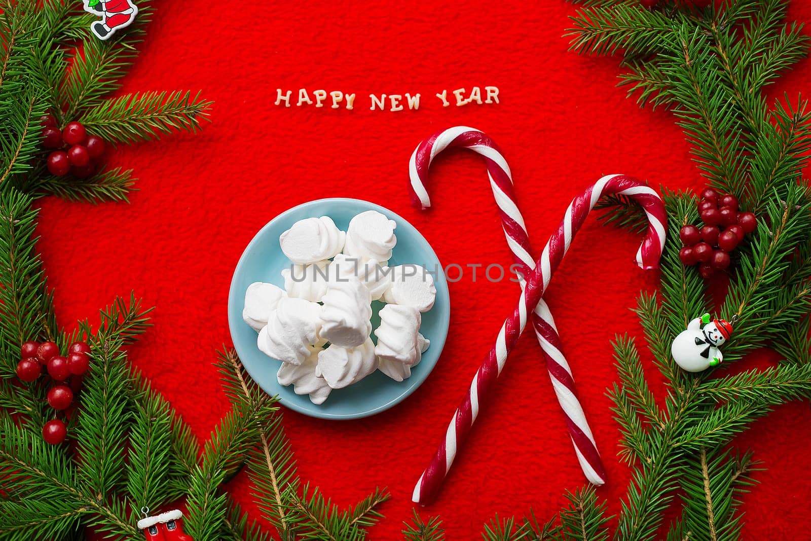 Christmas tree and candy on a red background with the words Happy New Year!