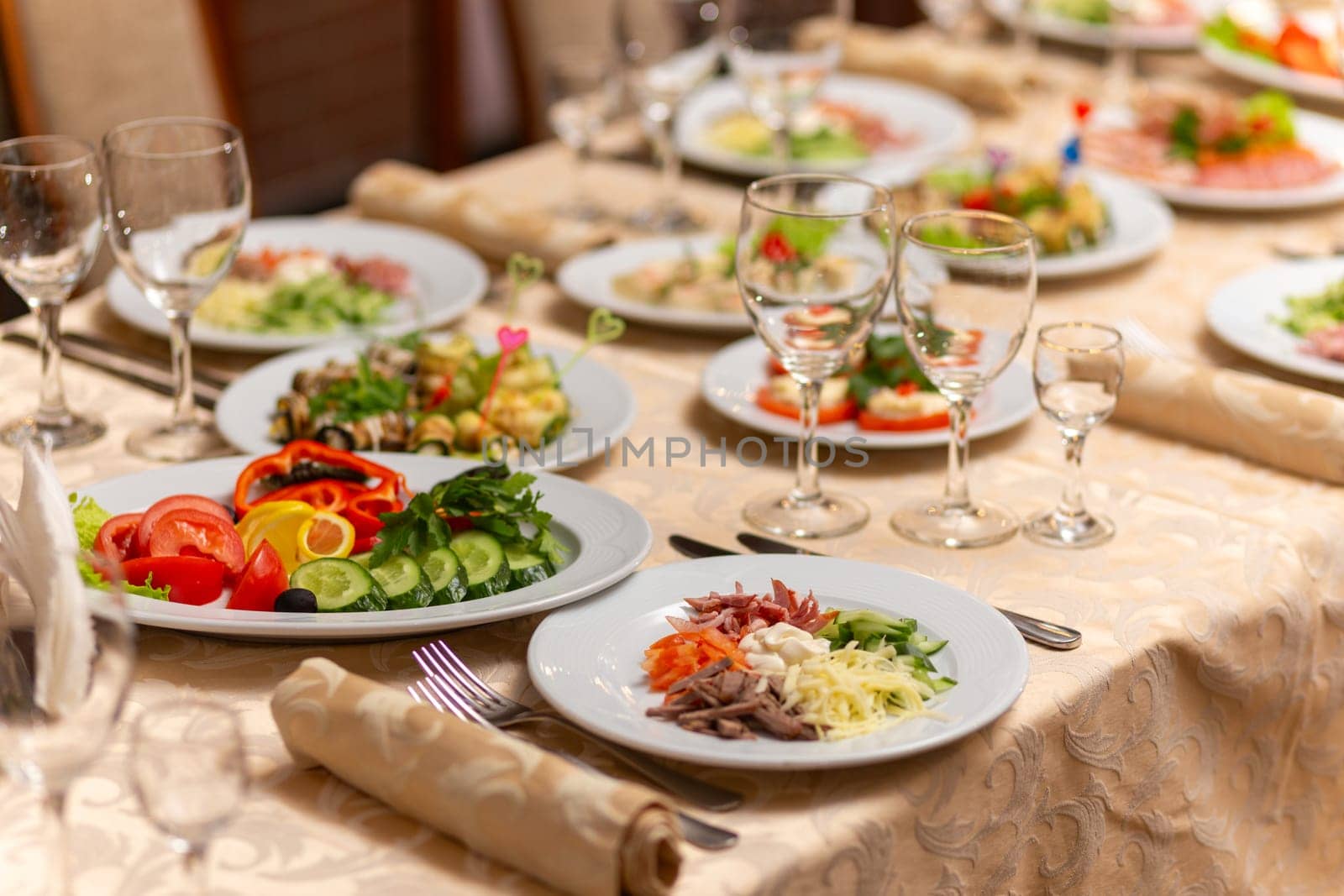 Served festive table with snacks, glasses, glasses, cutlery and napkins for a banquet on the occasion of a wedding or birthday or Christmas or other bright event in the restaurant