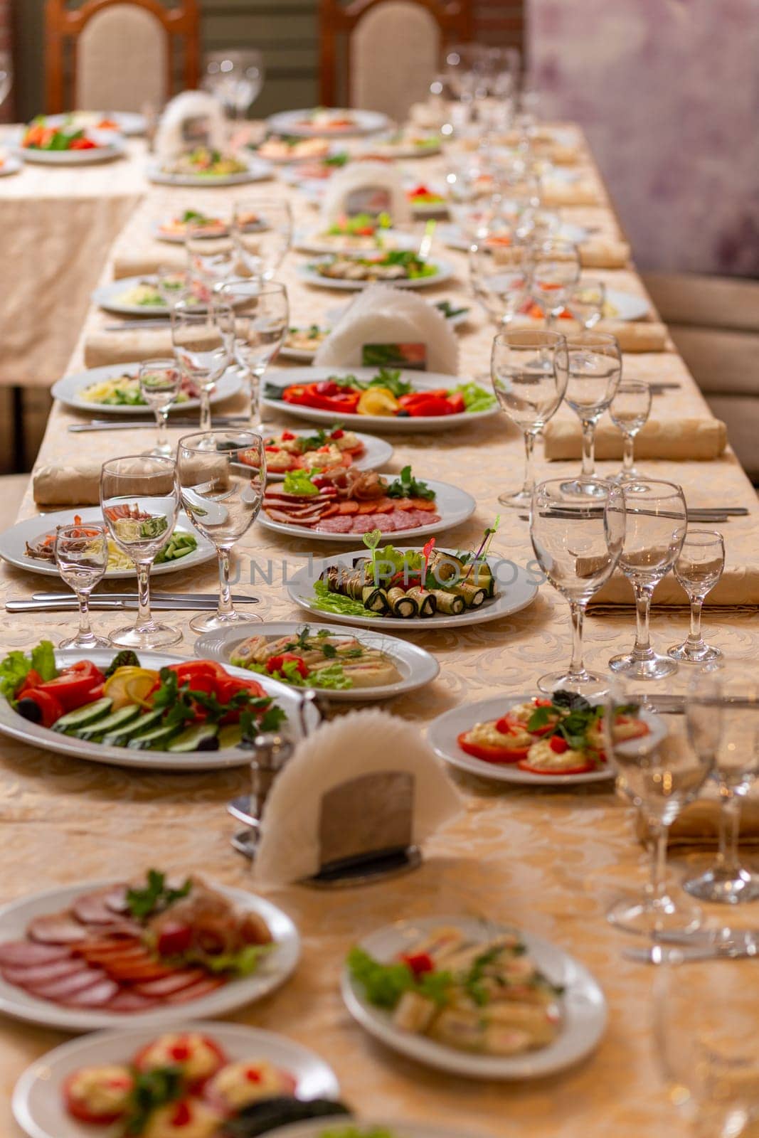 Served festive table with snacks, glasses, glasses, cutlery and napkins for a banquet on the occasion of a wedding or birthday or Christmas or other bright event in the restaurant