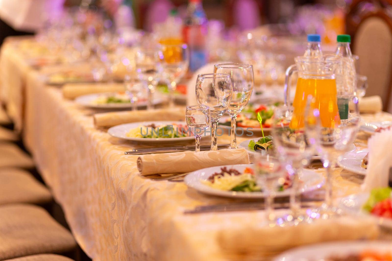 Served festive table with snacks, glasses, glasses, cutlery and napkins for a banquet on the occasion of a wedding or birthday or Christmas or other bright event in the restaurant