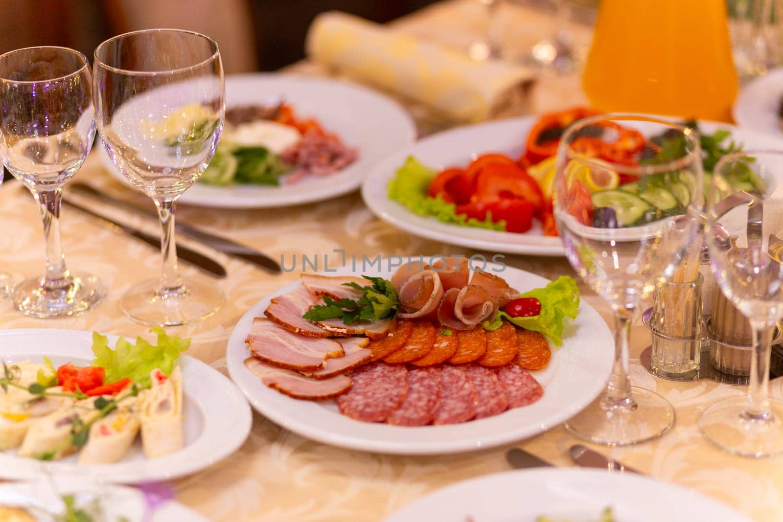 Served festive table with snacks, glasses, glasses, cutlery and napkins for a banquet by BY-_-BY