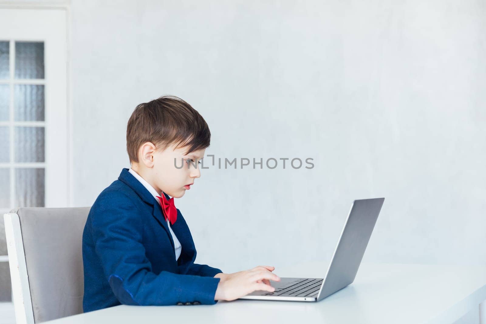 business boy. smiling child in glasses. little boss in office.funny kids
