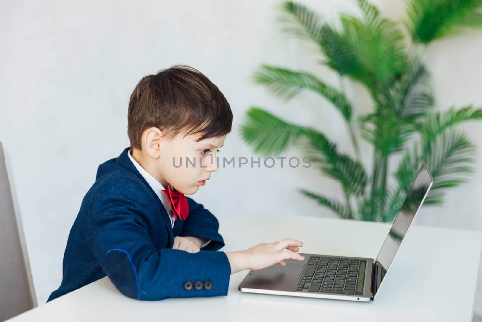 Young business boy. smiling child in glasses. little boss in office.funny kids by Simakov