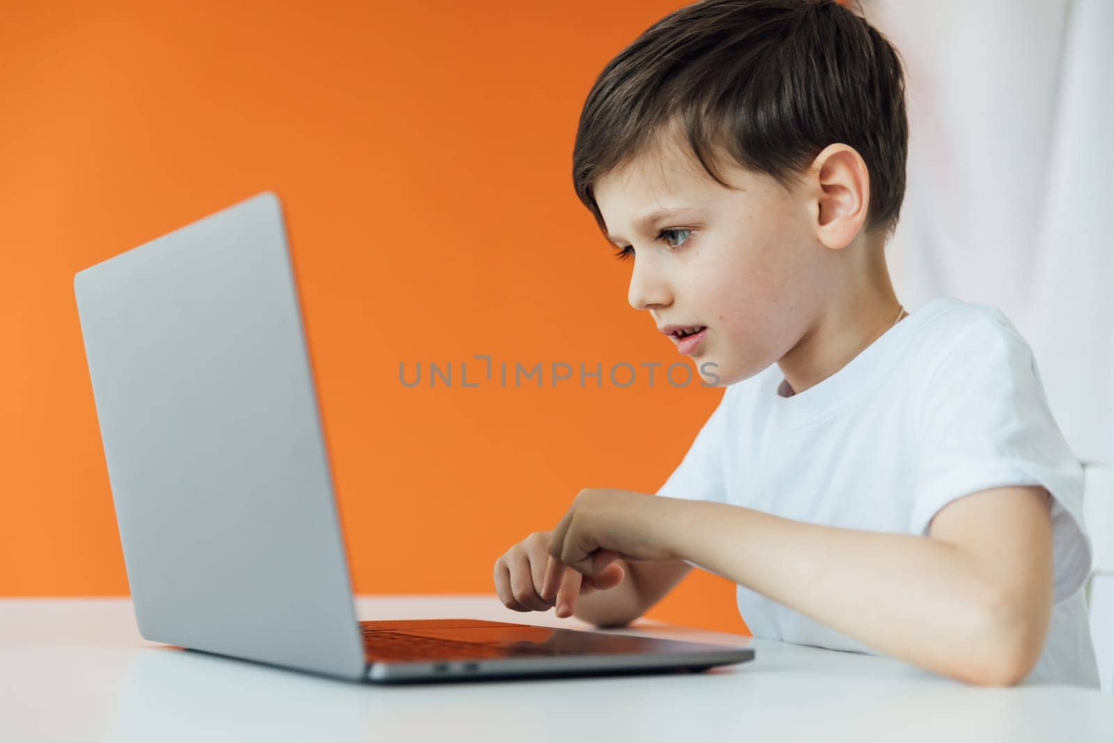 Little boy using laptop on white background