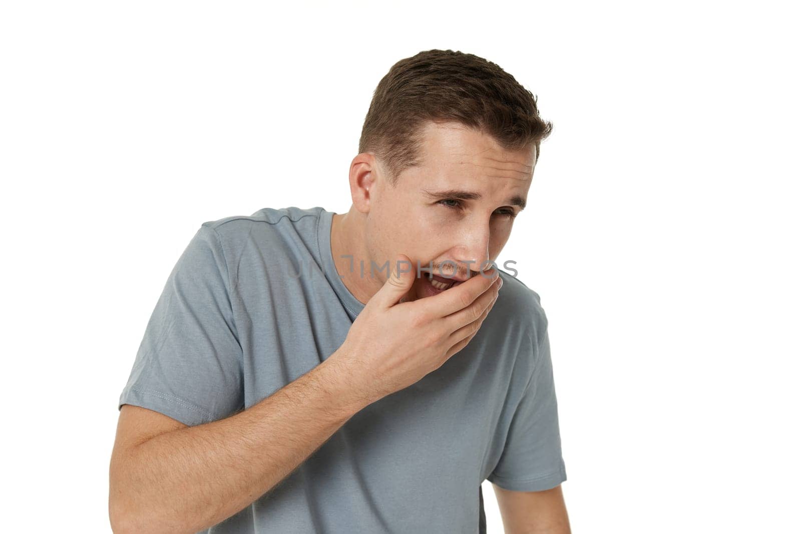 caucasian man suffers pain in throat and coughing on white background