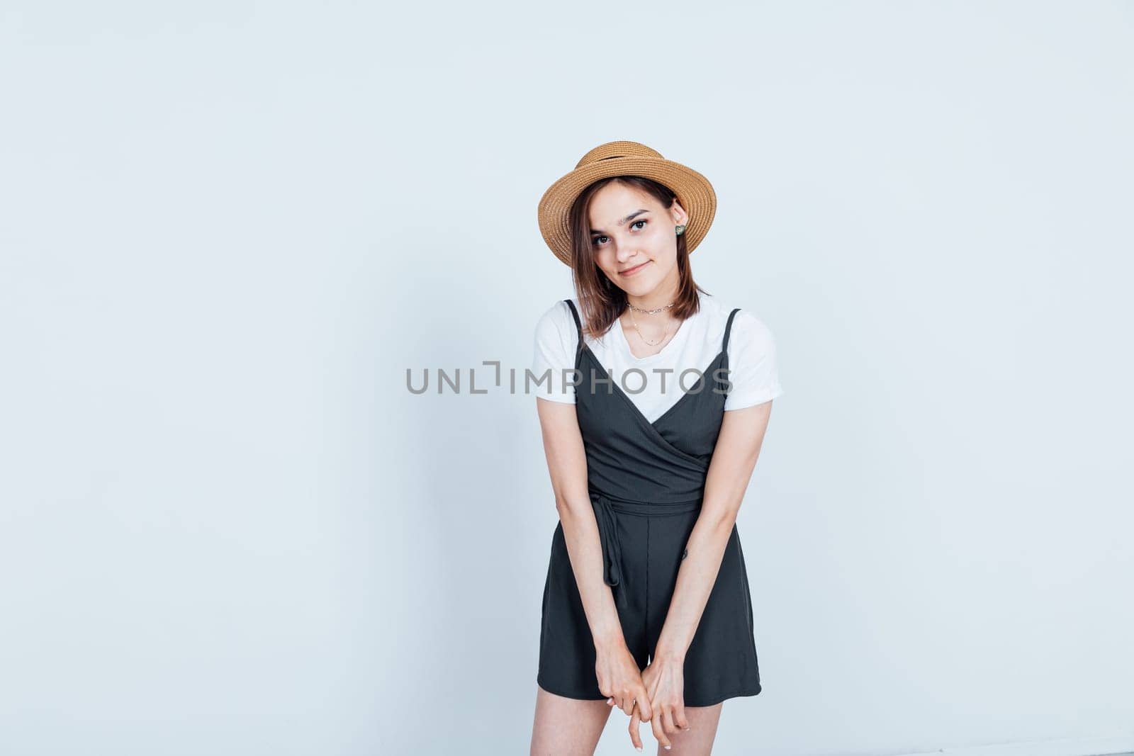 Portrait of a beautiful woman in a black dress and hat