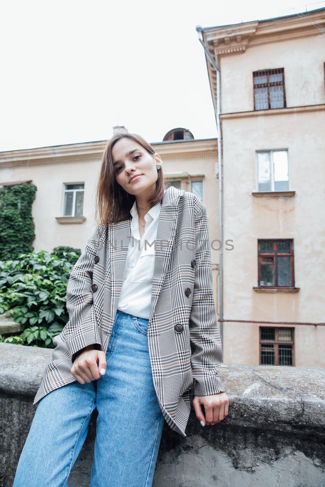 slender brunette woman walking in autumn city by Simakov