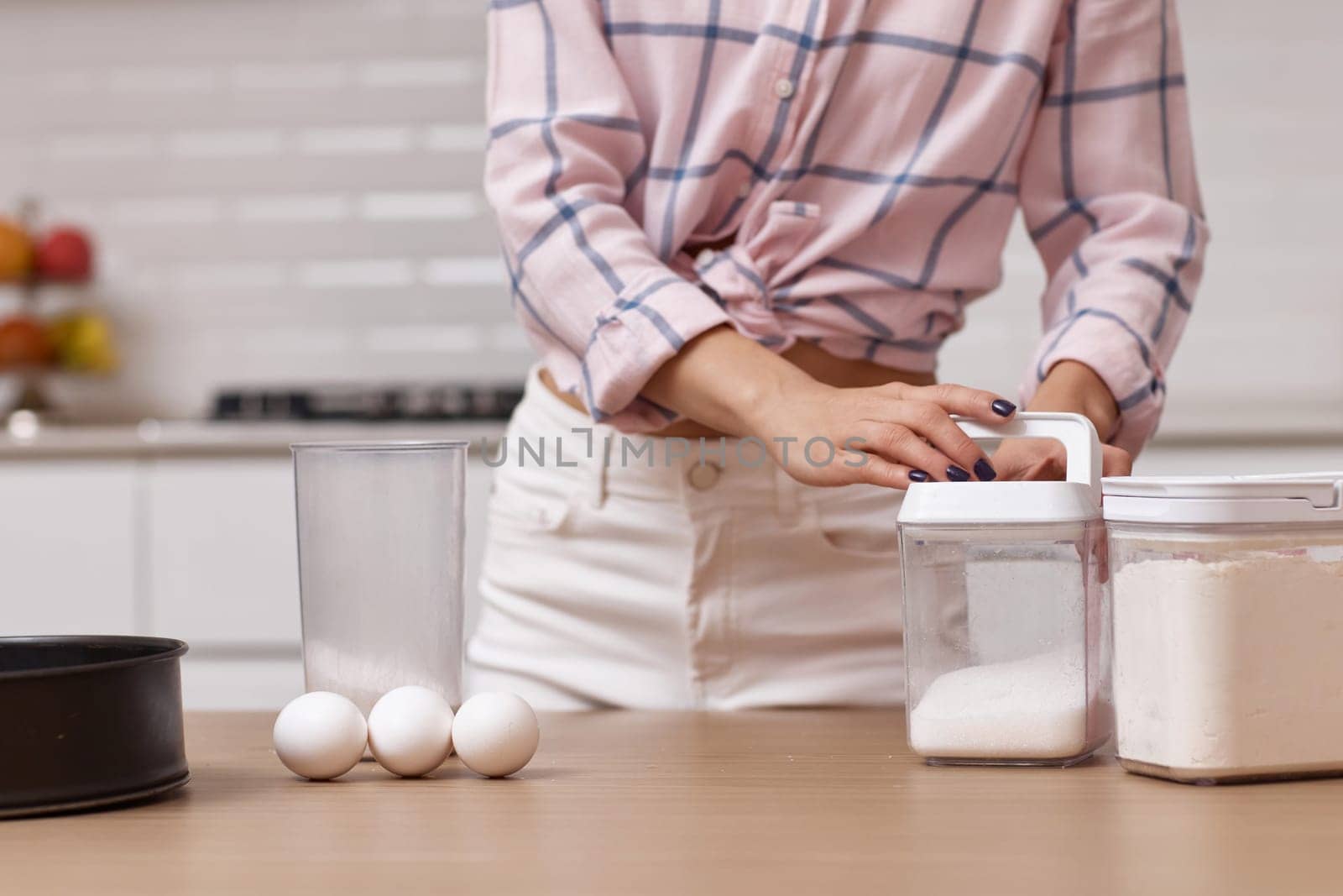 Happy baker woman preparing pie in modern kitchen
