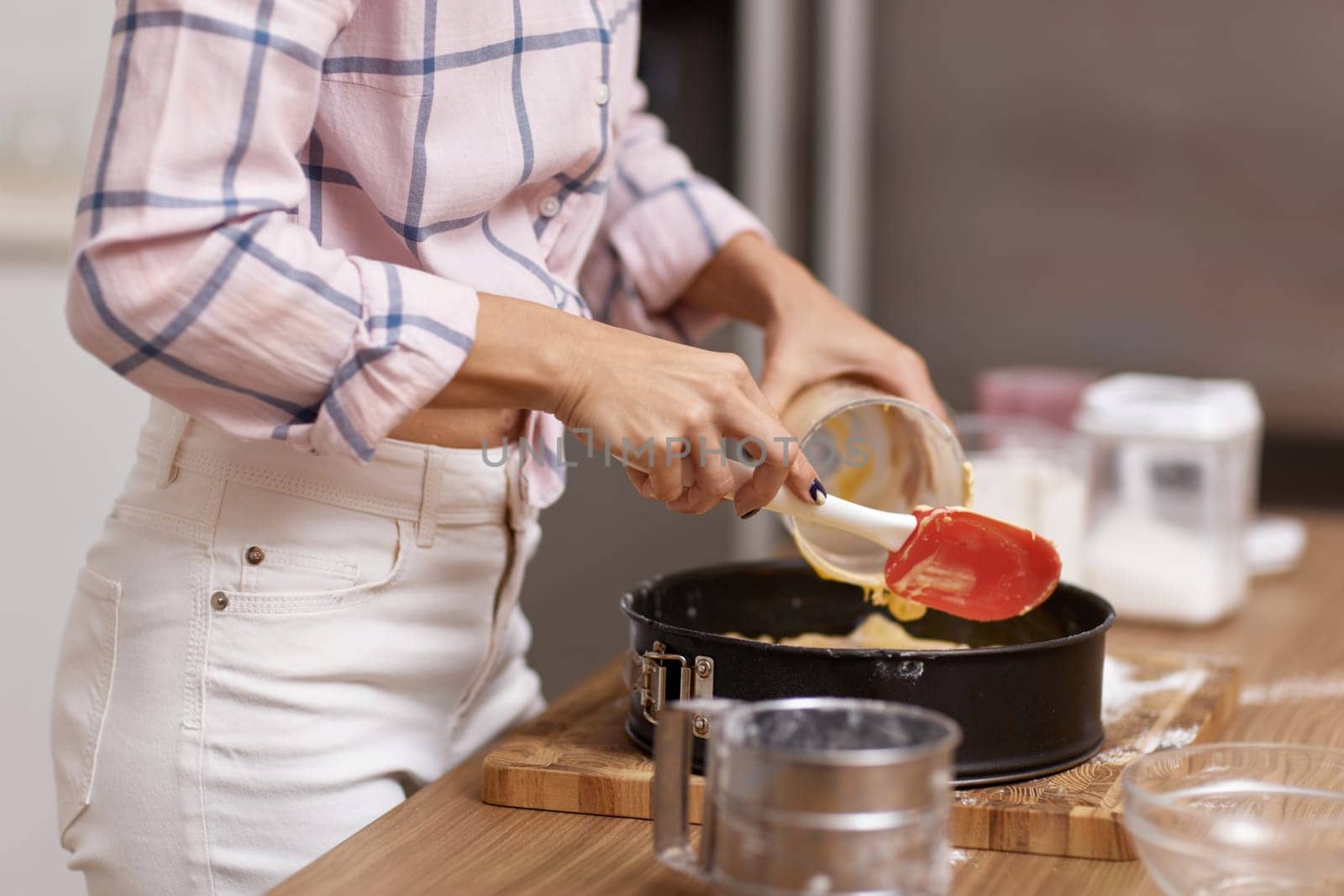 housewife woman baking pie in modern kitchen
